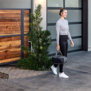 Person walking with RESTECK Massager in carrying case.