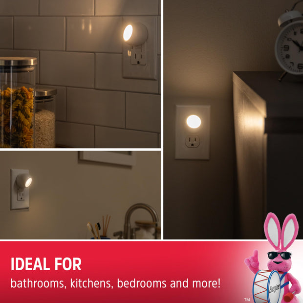 Soft white night light plugged into a bedroom wall outlet, providing gentle illumination.