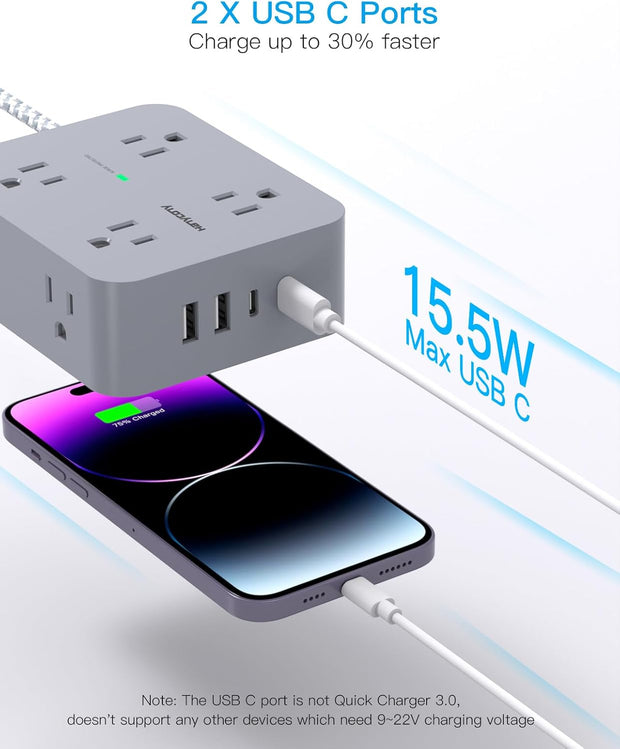 Wall-mounted surge protector power strip in a home office setup.